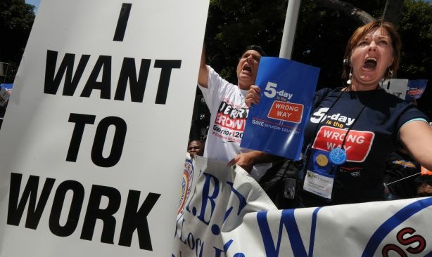 Americans hold up 'I want to work' placards as they join a protest of several thousand people demanding jobs outside City Hall in Los Angeles on August 13, 2010. A Labor Department report showed 131,000 jobs were lost in July and the unemployment rate remained stuck at 9.5 percent.