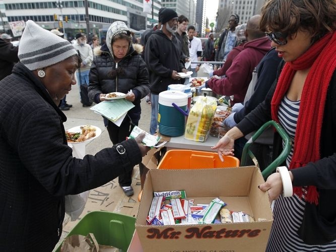 Volunteers distribute food outside a Philadelphia Department of Public Health hearing in March on rules banning outdoor food distribution.