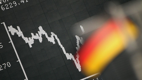 Frankfurt: A German flag hung June 18, 2012 in front of a board displaying the DAX stock index.