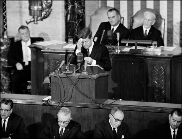 US President John F. Kennedy (C) wipes his forehea
