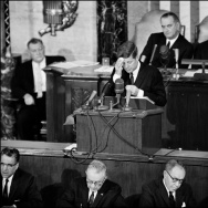 US President John F. Kennedy (C) wipes his forehea