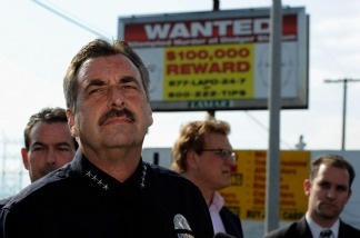 LAPD Chief Charlie Beck stands in front of one of 300 billboards showing a wanted poster for two suspects for the beating of a San Francisco Giants fan Bryan Stow.