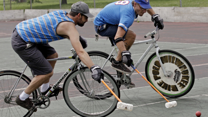 Jacob Newborn takes a shot past Lodewijk Broekhuizen, left, during a bike polo practice session in Milwaukee.