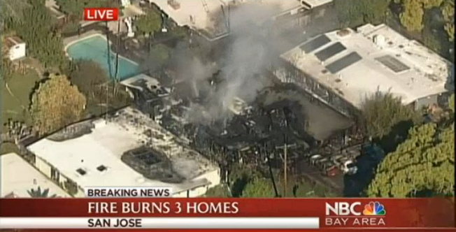One home has been destroyed and others are threatened in a fire near a mall in San Jose Monday.
