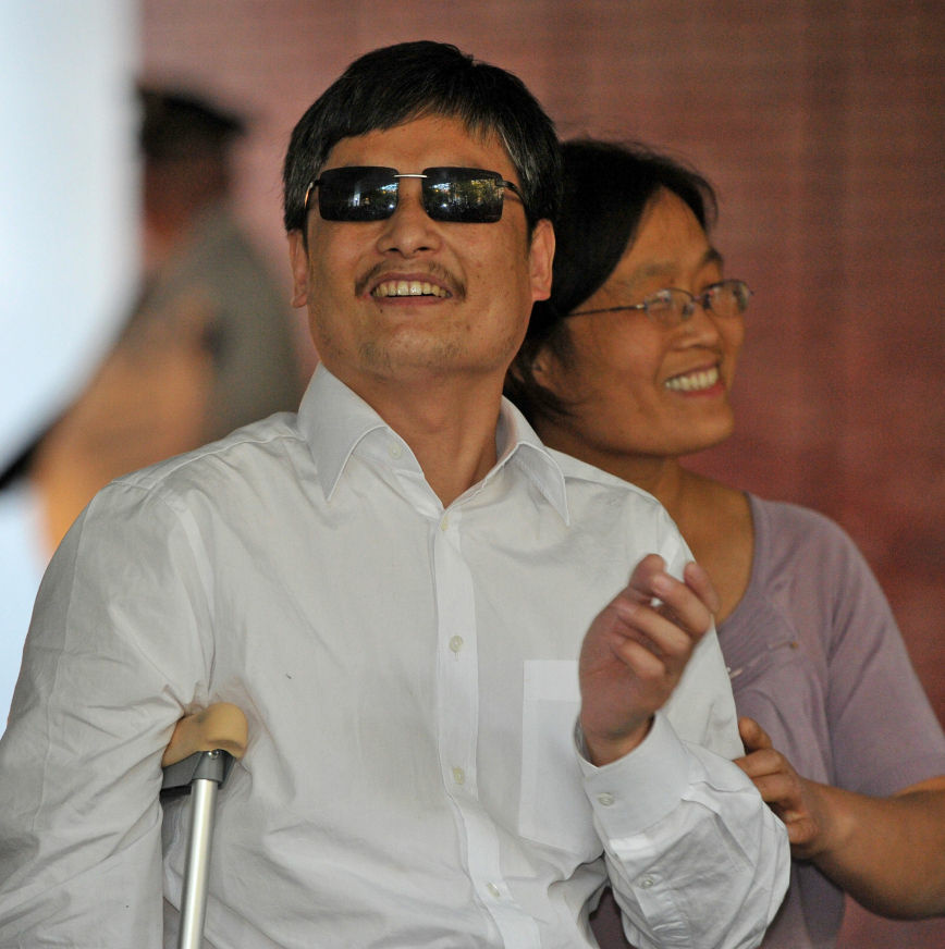 Chinese activist Chen Guangcheng and his wife Yuan Weijing arrive at the New York University Village apartment complex in New York Saturday.