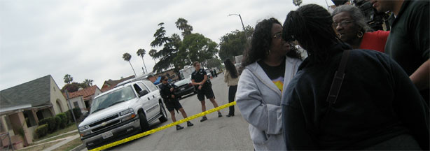 Police and local residents gather near the house of Lonnie Franklin Jr., 57, in South Los Angeles.