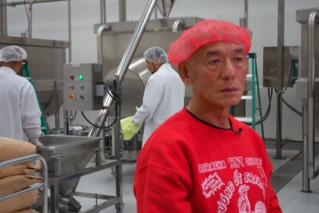 Huy Fong Foods Inc. owner David Tran with machines that mix Sriracha chili sauce ingredients, including crushed jalapeño chilis from Ventura County, sugar, spices and garlic.