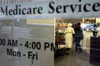 File: Two people walk inside a Medicare Services office.