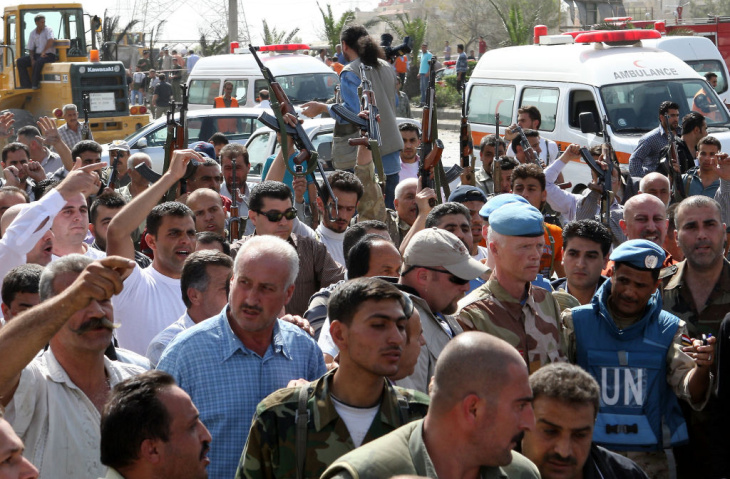 Syrian security forces raise their weapo