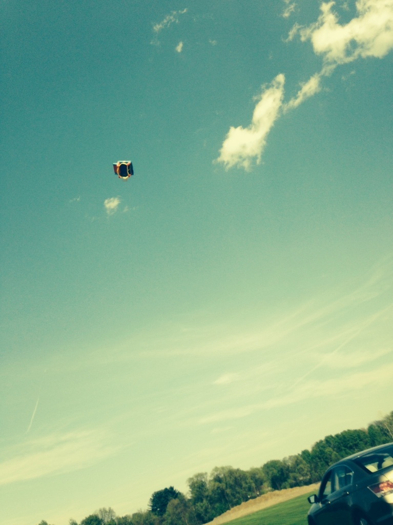 An eyewitness photo shows an inflatable playhouse being blown high in the air after three children fell out of it, injuring two of them seriously. Proceeds from the licensing of this image are being donated to the kids' families.