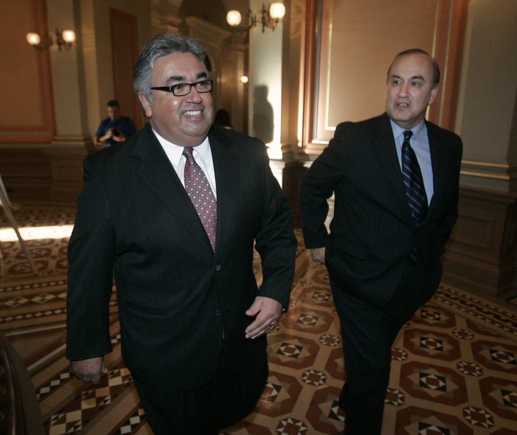 State Sen. Ron Calderon, D-Monterey Park, left, smiles as he walks through the Capitol with his brother, former assemblyman Charles Calderon, D-Whittier, after his early primary measure was approved by the Assembly at the Capitol in Sacramento, Calif., Tuesday, March 6, 2007.