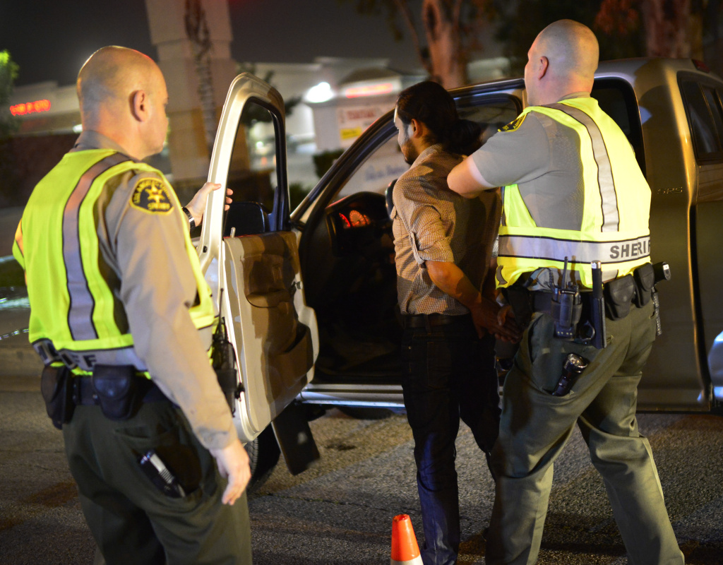 Los Angeles Sheriff's Department deputies stop a man at a DUI checkpoint in Bellflower. He was later released after passing a breathalyzer test.