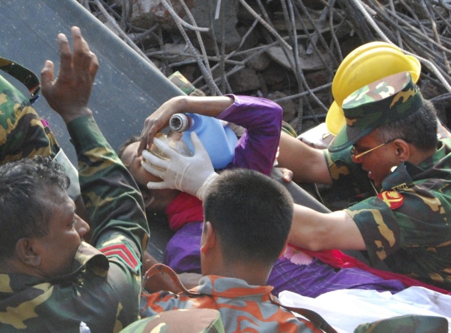 Rescuers carry a survivor who was buried for 17 days under the rubble of a building that collapsed in Saver, near Dhaka, Bangladesh.