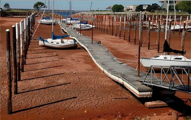 Sailboats and a floating dock lie on the dry, cracked dirt in a harbor at Lake Hefner in Oklahoma City during a 2011 drought.