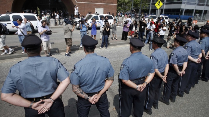 MIT police officers stand at attention outside a federal courthouse where Boston Marathon bombing suspect Dzhokhar Tsarnaev pleaded not guilty to 30 counts today. He is also accused in the death of MIT officer Sean Collier.