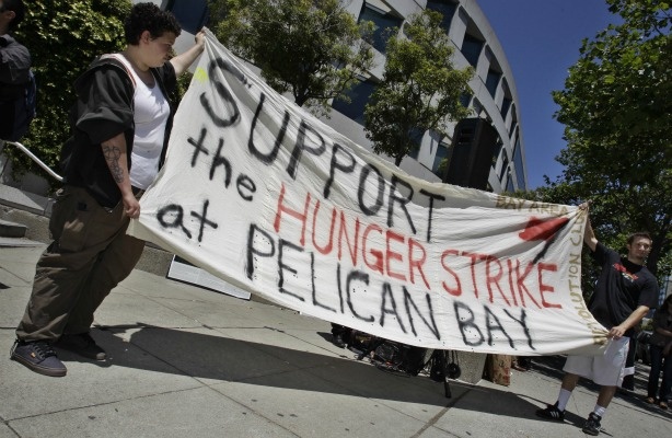 Demonstrators hold up a sign during a rally in front of the State Building in San Francisco on July 1, 2011 to support prisoners at Pelican Bay State Prison.