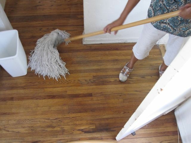 An undocumented housekeeper on her cleaning rounds, mopping a Los Angeles apartment, October 2010