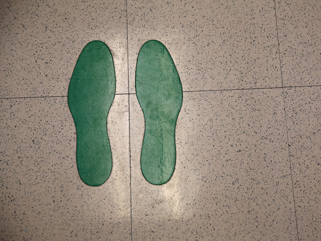 Footprints mark the spot where immigrants stand while taking eye tests at the Salud Family Health Clinic in Ft. Collins, Colo. The nonprofit provides health care to immigrants seeking asylum and migrant farm workers.