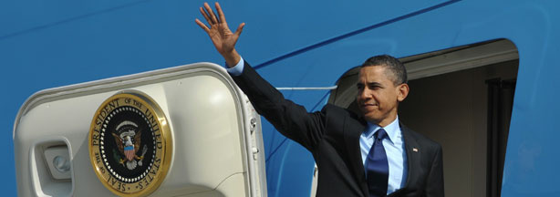 President Barack Obama makes his way aboard Air Force One.
