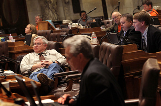 Wisconsin State representatives start to fade as they listen to arguments on one of the expected 200 amendments to Gov. Scott Walker's budget repair bill in the early morning hours on February 24, 2011 in Madison, Wisconsin.