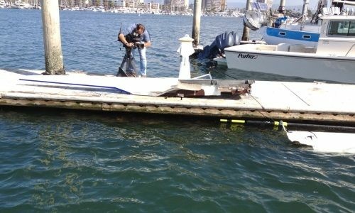 Authorities photograph a vessel that was completely destroyed in a collision with another boat in the Marina Del Rey Main Channel on Sunday, May 27, 2012.