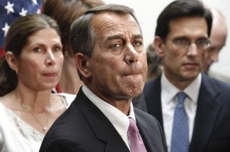 House Speaker John Boehner of Ohio, flanked by House Majority Leader Eric Cantor, R-Va., right, and Rep. Mary Bono Mack, R-Calif., pauses during a news conference on Capitol Hill on April 8, 2011.