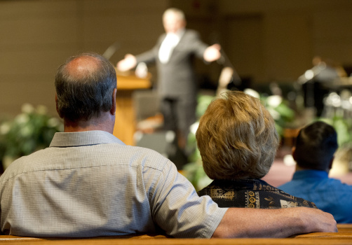 Worshippers listen to a sermon during a