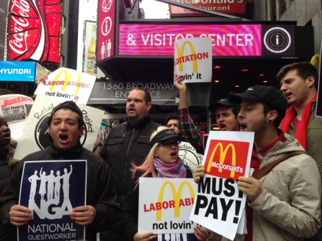Workers and labor organizers in New York City protest the alleged exploitation of students on J-1 summer work travel visas who worked at a Pennsylvania McDonald's, on Thursday.