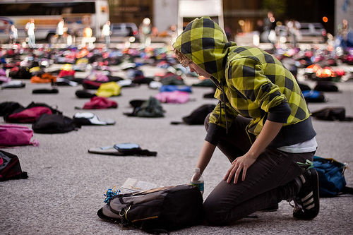 A student approaches a backpack that is part of a Send Silence Packing exhibit. The project is currently touring around the Southland.