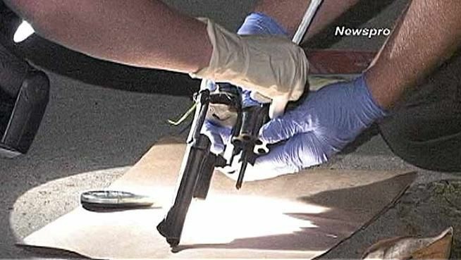 Police recover a revolver used in a gunfight in a San Bernardino park in which two men were killed, a woman gravely injured and another man shot in the foot.