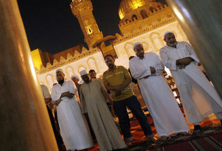 Muslim Egyptian men pray during the Islamic holy month of Ramadan at Cairo's historic Al-Azhar mosque in September 2009. Some experts say many Egyptians have lost the meaning of the holy month, spending too much time after hours partying, eating and watching TV.