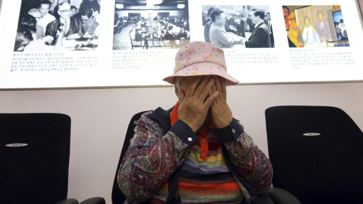 South Korean Cho Jang-geum, 81, weeps as she fills out an application to reunite with family members who live in North Korea, at the headquarters of the Korean Red Cross in Seoul Saturday. North Korea announced today that it is indefinitely postponing the reunions of families who were separated by the 1950-53 Korean War. The meetings were to take place in the coming week.