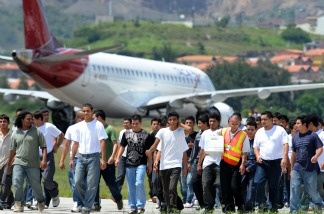 Honduran migrants deported from the United States walk on the tarmac of Toncontin Airport in August, 2011. With immigration reform unlikely in 2014, immigrant rights advocates have stepped up their push for the Obama administration to halt deportations. The White House announced last week that it would review deportation practices.