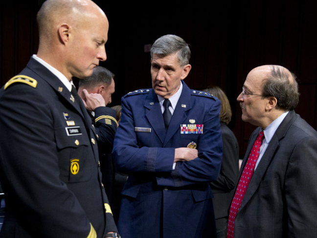 Lt. Gen. Richard Harding, Air Force judge advocate general, center, speaks with Army Lt. Gen. Dana Chipman, left, and Robert Taylor, acting general counsel of the Defense Department, prior to testifying before the Senate subcommittee on sexual assault on