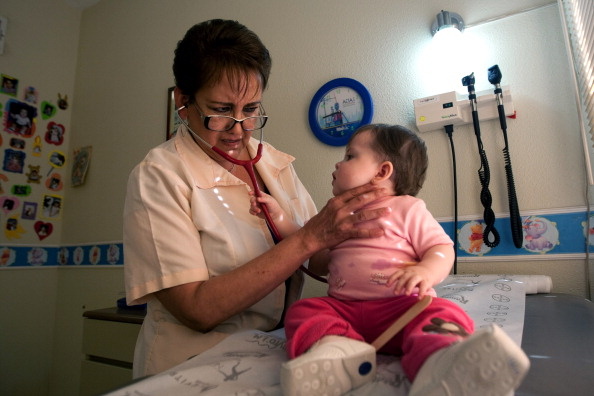 Pediatrician Elsa Maldonado examines a c