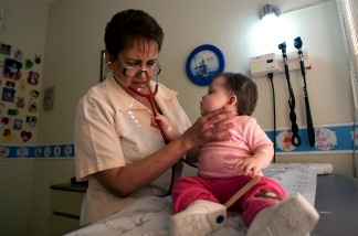 Pediatrician Elsa Maldonado examines a child at her office.