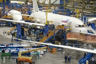 Boeing employees work on a Boeing 787 Dreamliner on one of the assembly lines February 14, 2011 at the company's factory in Everett, Washington. U.S. factory orders increased in December even though companies trimmed their orders for goods that signal investment plans. The Commerce Department says factory orders rose 1.8 percent in December compared to November, when orders had fallen 0.3 percent.