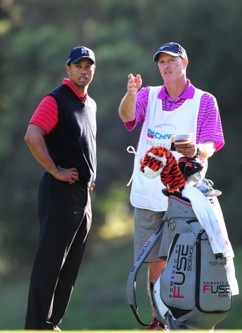 US golfer Tiger Woods (L) and his caddie