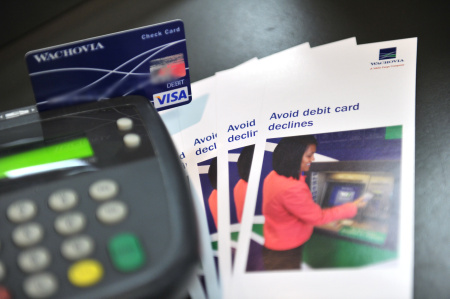 A photo illustration shows a debit card