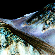 This image from NASA's Mars Reconnaissance Orbiter shows dark, narrow streaks on the slopes of Hale Crater that were thought to be created by water, but are now under question. 