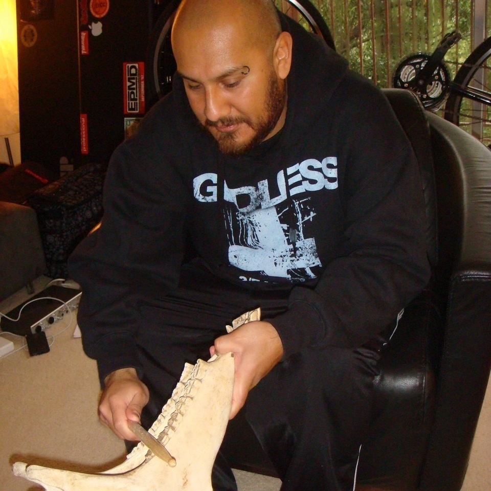 Marco Santiago plays a quijada in his home.