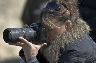 A female photographer in Morro Bay, California.