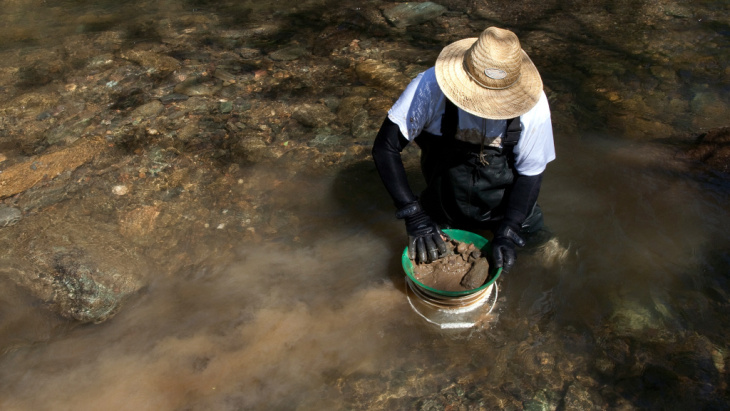 A man looks for gold in Woods Creek in Jamestown, Calif., in 2011.