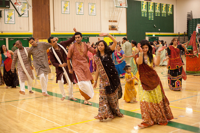 A group participates in garba, a folk dance that originated in India.