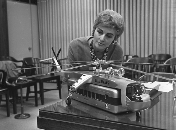 A model of a helicopter with passenger-carrying pod is inspected by Ann Orbeck on April 3, 1965.
