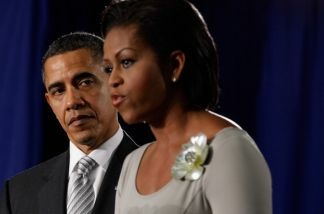 U.S. President Barack Obama (L) listens as first lady Michelle Obama delivers remarks before the president signs the Healthy, Hunger-Free Kids Act of 2010 at Harriet Tubman Elementary School December 13, 2010 in Washington, DC.