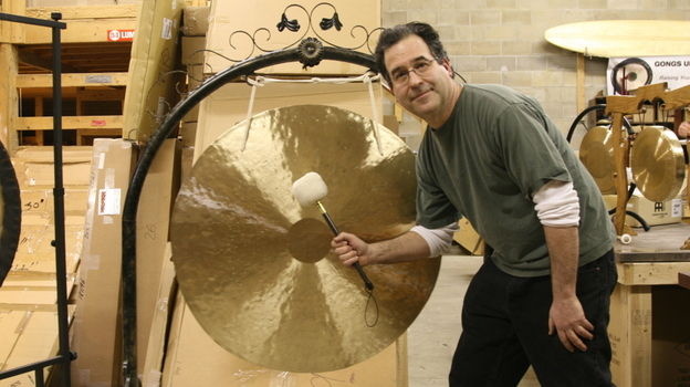 Andrew Borakove with one of his many gongs for sale.