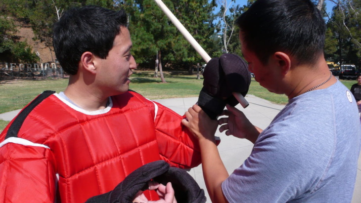 Reporter Jed Kim suits up for an eskrima sparring match