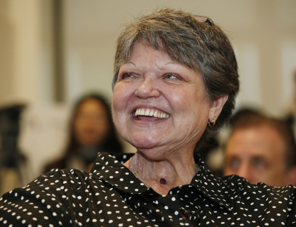 In this Dec. 20, 2010 file photo, tobacco educator Debi Austin comments on the negative effects of tobacco during a news conference in Los Angeles. Austin, a woman who smoked a cigarette through a hole in her throat to illustrate her struggle of nicotine addiction in a California public service advertisement, has died after a long struggle with cancer, health officials and her family said Wednesday Feb. 27, 2013.