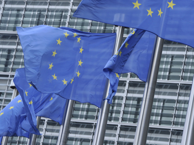 European Union flags fly in front of the organization's headquarters in Brussels.